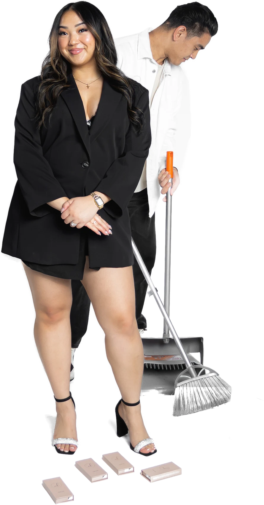 Rikki and Abraham, the founders of Besmi, in their studio: Rikki in a black blazer, Abraham behind her with a broom