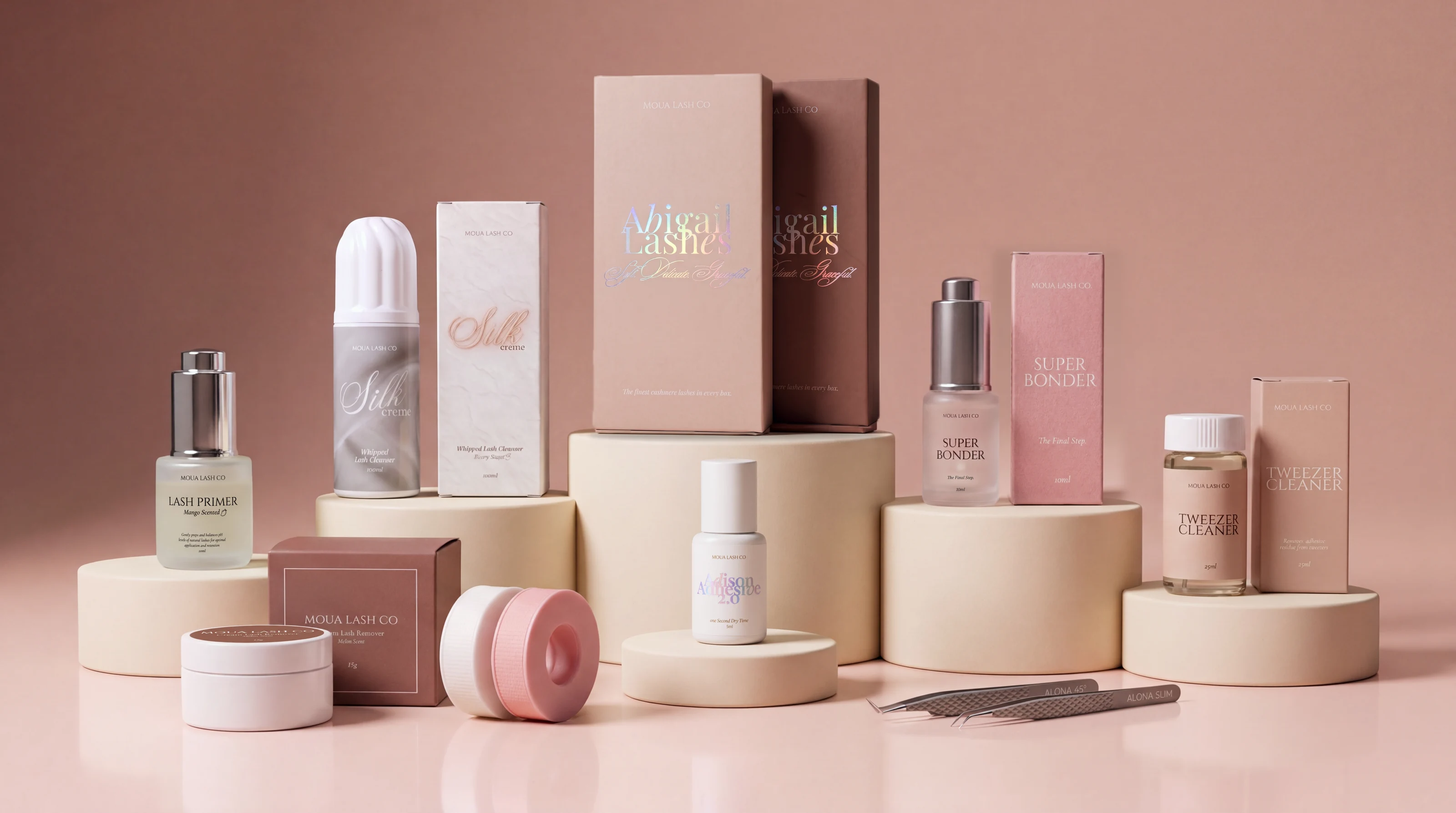 The Moua Lash Co line together: Silk Crème cleanser, Lash Primer, black and brown Abigail Lashes boxes, Adison Adhesive 2.0, Super Bonder, Tweezer Cleaner, Jelly Tape and Alona tweezers